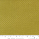 A close-up of a fabric swatch showing a mustard yellow background with a small white polka dot pattern, with a ruler and Modla branding along the bottom edge.