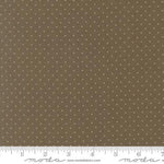 Brown fabric with a repeating pattern of small white dots, shown with a ruler at the bottom for scale. The brand name 'Moda Fabrics' is visible on the ruler watermark.