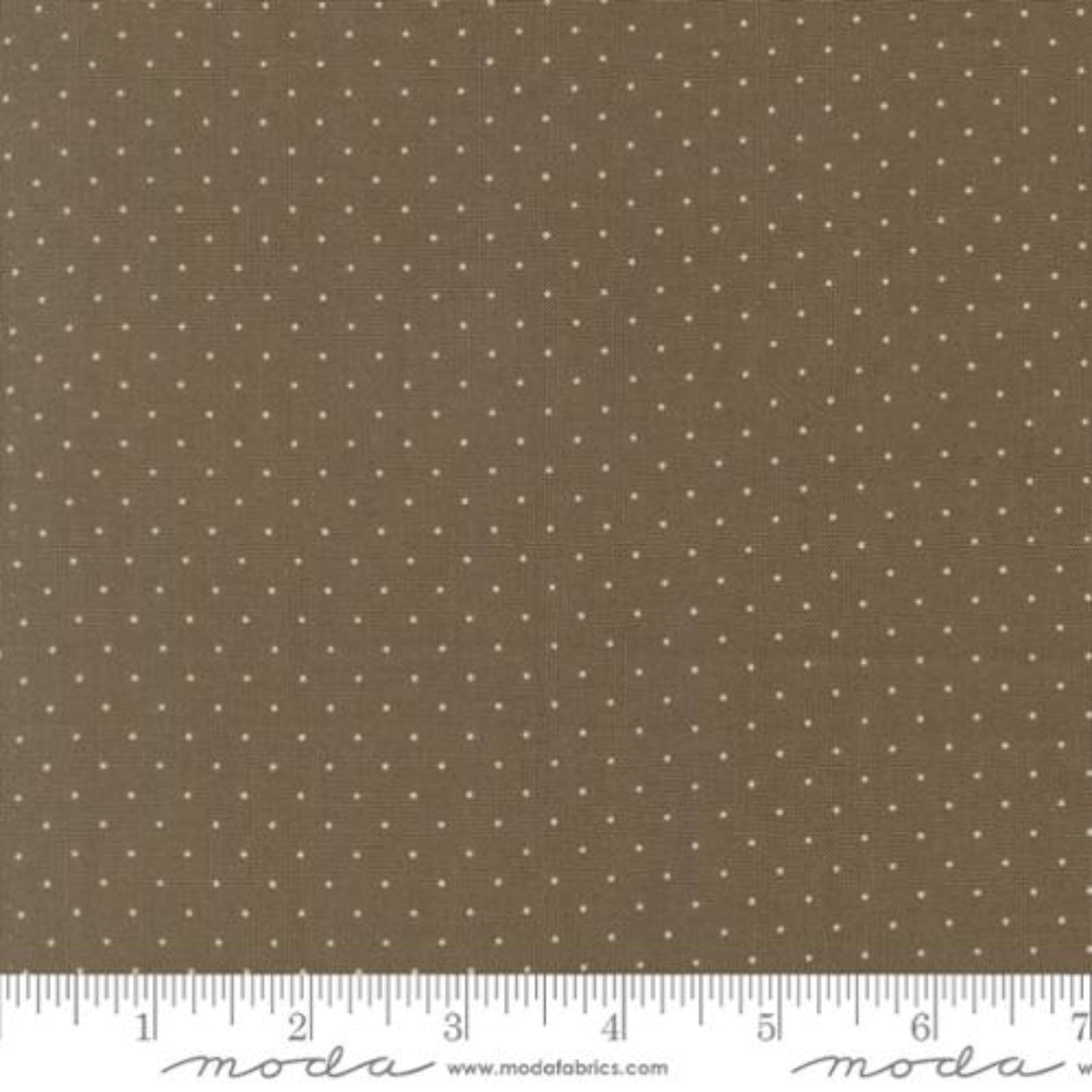 Brown fabric with a repeating pattern of small white dots, shown with a ruler at the bottom for scale. The brand name 'Moda Fabrics' is visible on the ruler watermark.