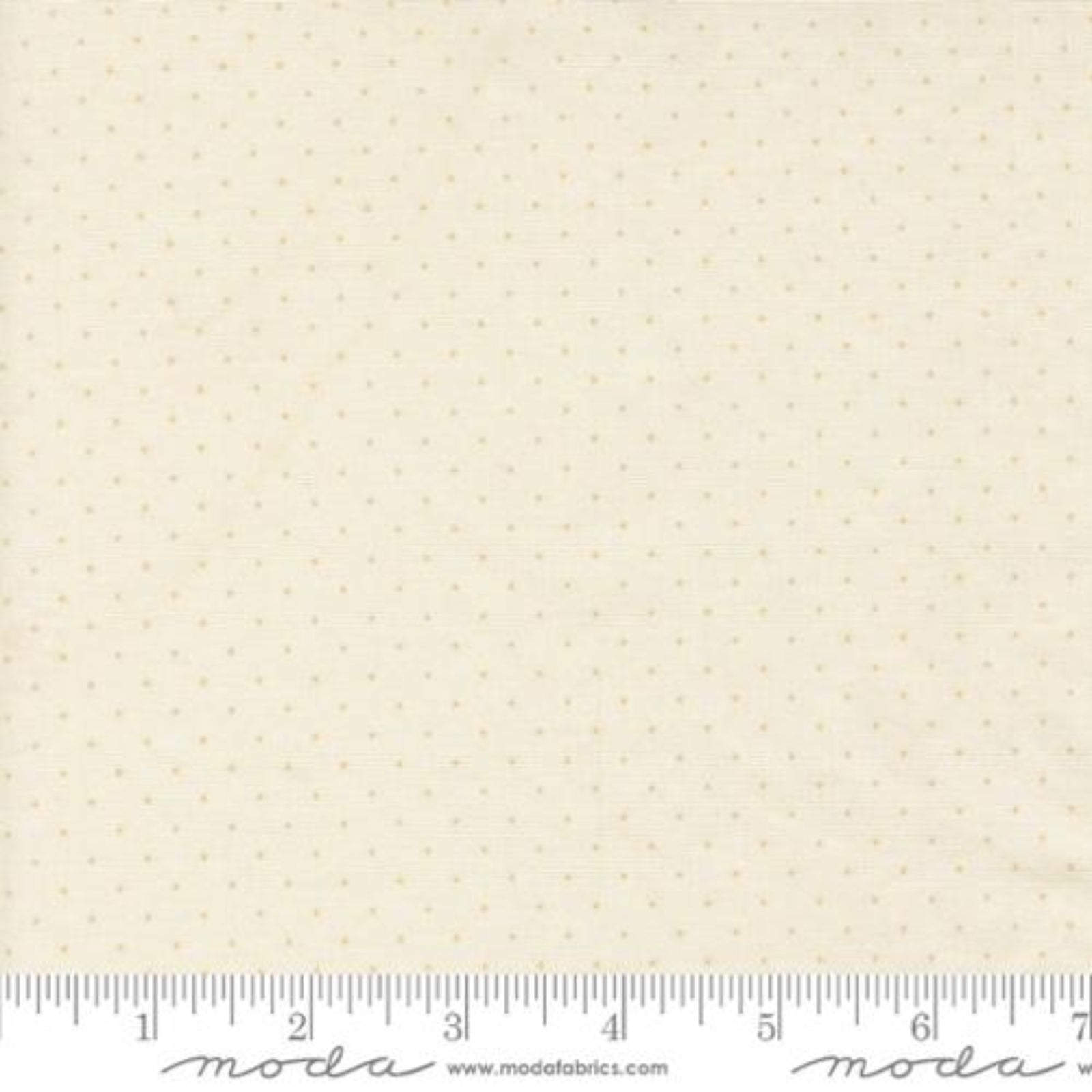 A close-up of a fabric swatch with a repeating small gold dot pattern on a warm cream background, with a measuring ruler along the bottom edge showing scale. The brand name 'Moda Fabrics' is printed on the ruler.