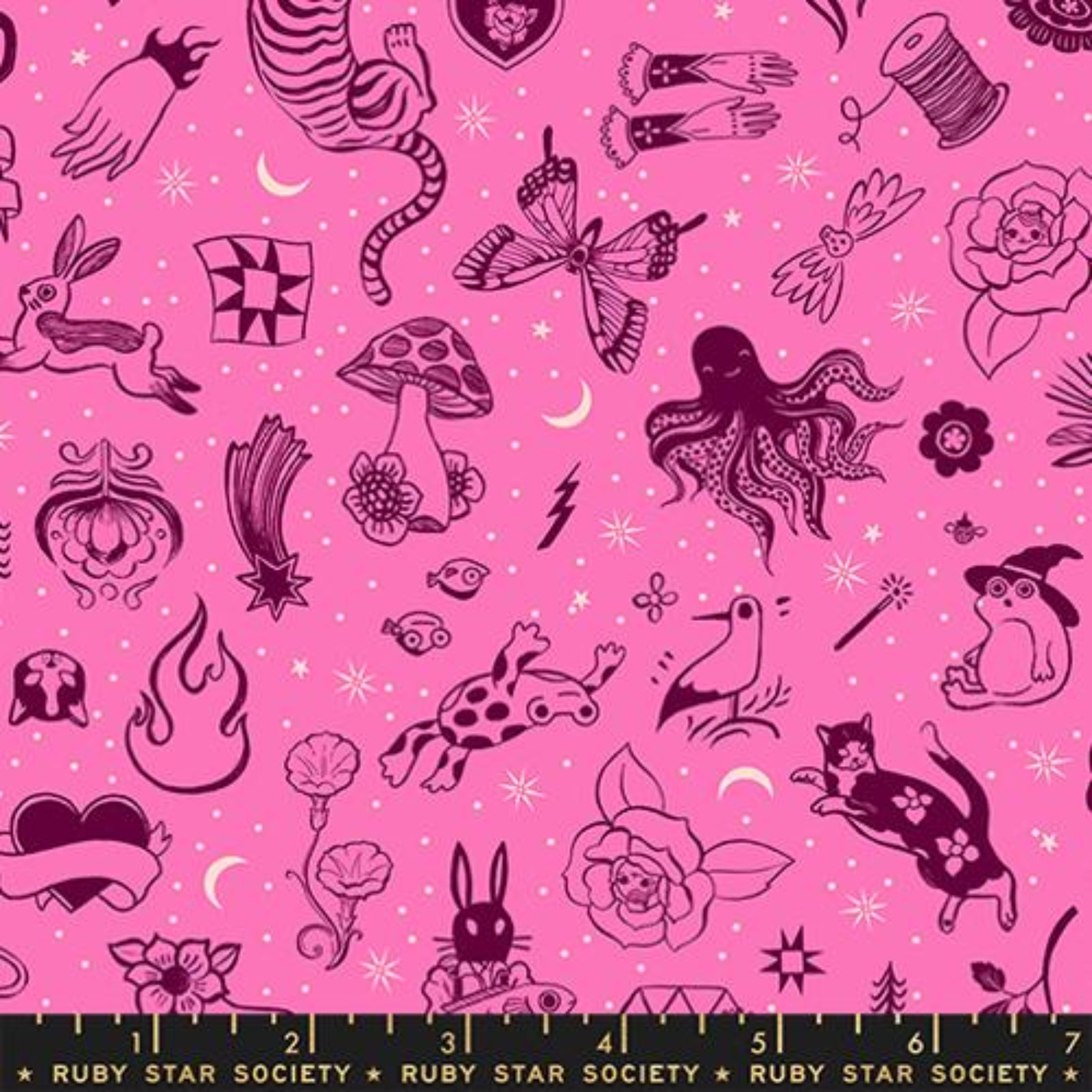 A flat lay of a fabric pattern featuring whimsical black line-art illustrations of fairies, flowers, stars, and nature motifs on a light blue background, with a Ruby Star Society ruler shown along the bottom edge.