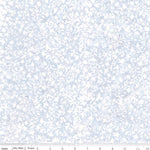 A close-up of a fabric pattern showing a delicate, repeating floral and leaf motif in light blue and white. A ruler at the bottom edge indicates the scale of the print.