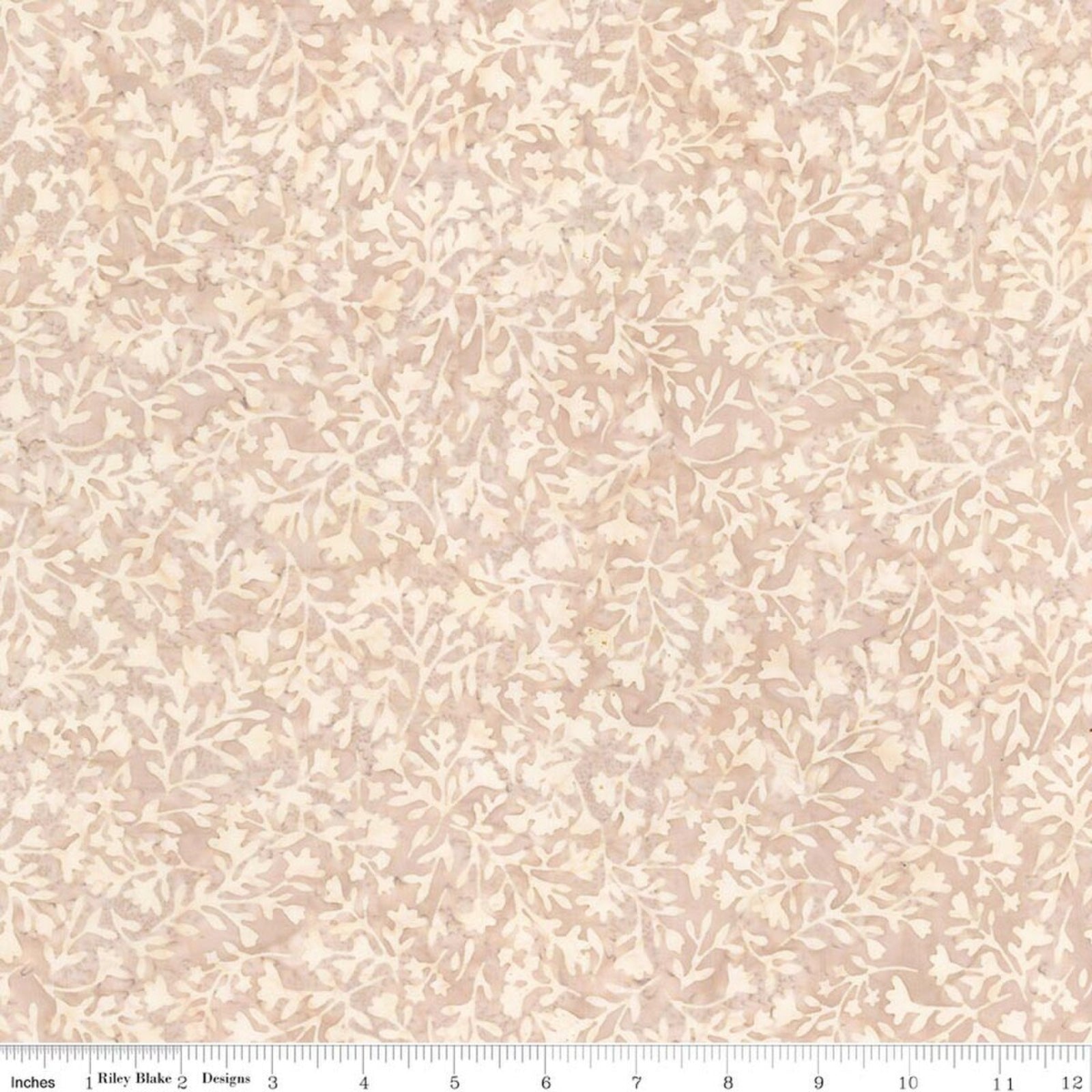 A close-up of a fabric pattern with a delicate beige and cream floral vine design on a light blush pink background, with a ruler at the bottom indicating scale.