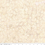 A close-up of a fabric pattern featuring a repeating leafy coral or sea-plant motif in cream and light beige on a warm off-white background, with a measuring ruler visible along the bottom edge.