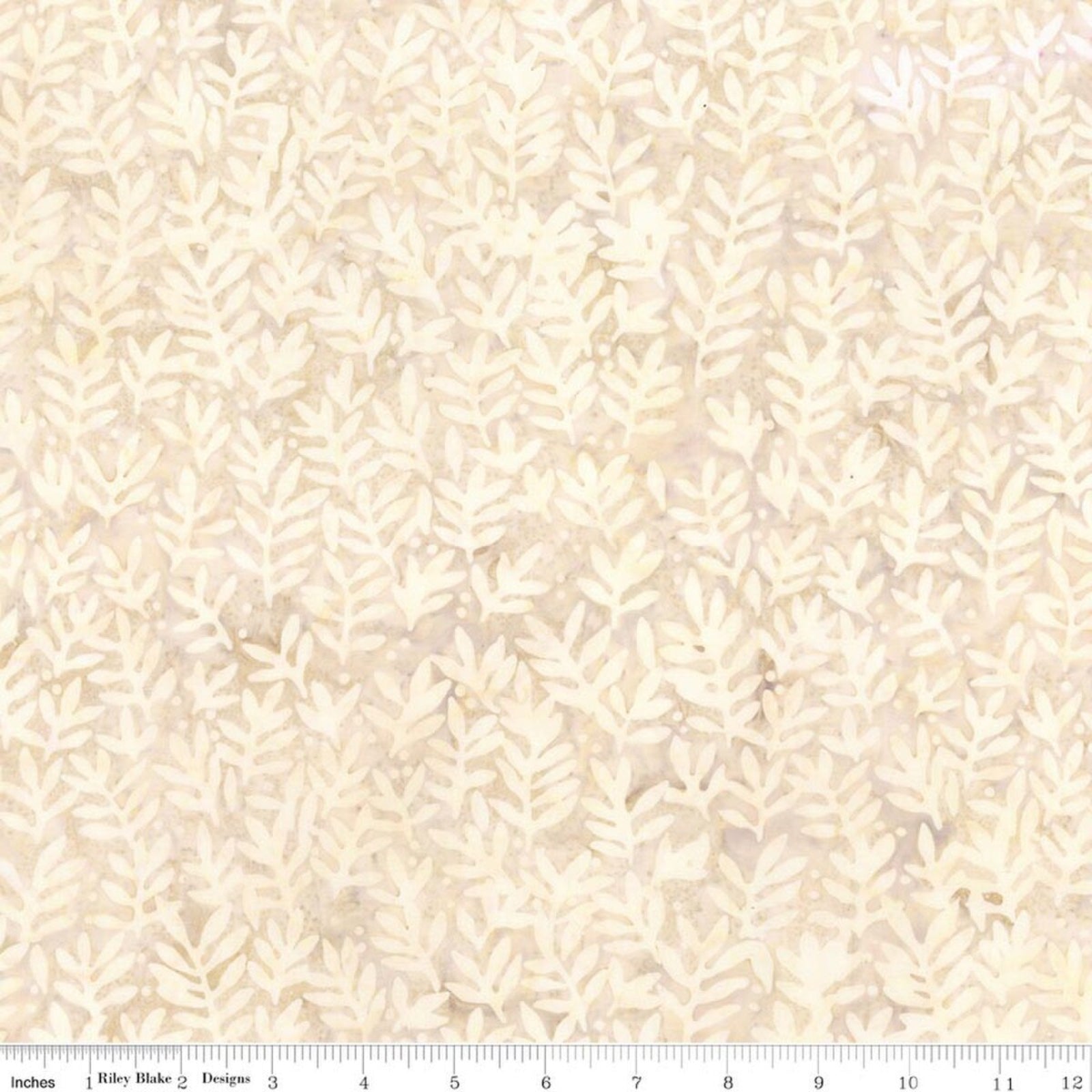 A close-up of a fabric pattern featuring a repeating leafy coral or sea-plant motif in cream and light beige on a warm off-white background, with a measuring ruler visible along the bottom edge.