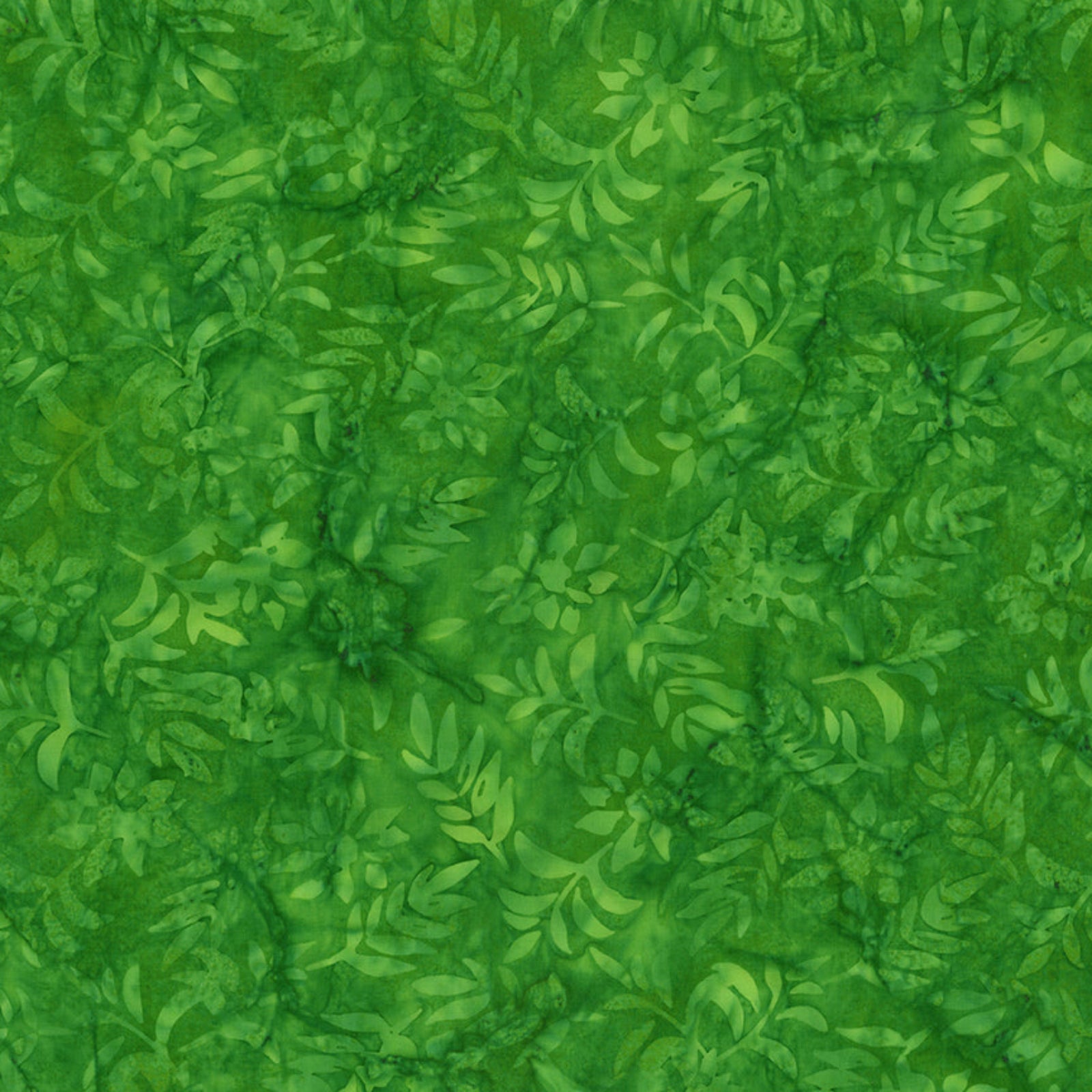 A close-up of a green batik fabric with a leafy vine pattern, featuring various shades of green in a marbled, textured design.