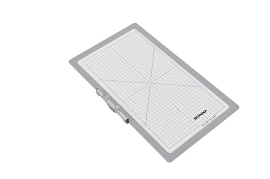 Embroidery hoop with grid lines and brand name on a white background