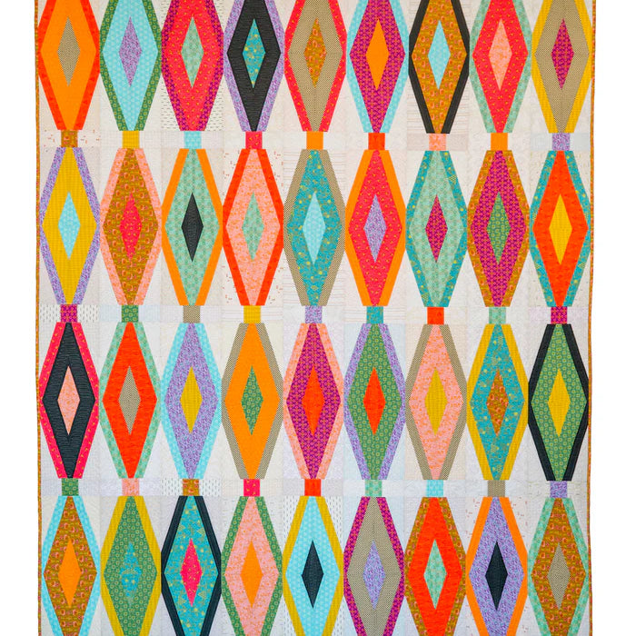 Breezeway quilt with colorful angled diamond blocks on a light background.
