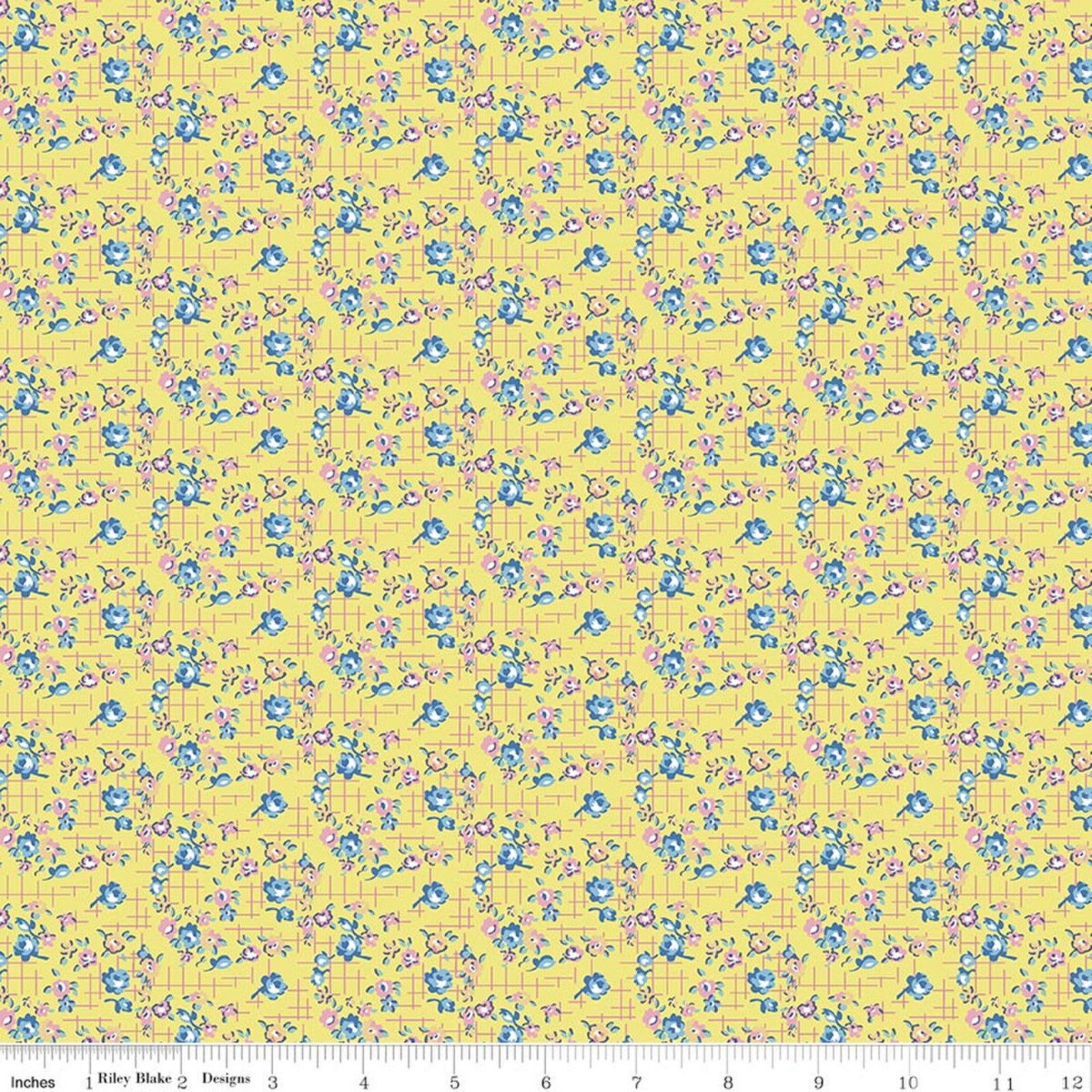 Yellow fabric with a repeating floral pattern in blue and pink, shown with a ruler at the bottom indicating scale.
