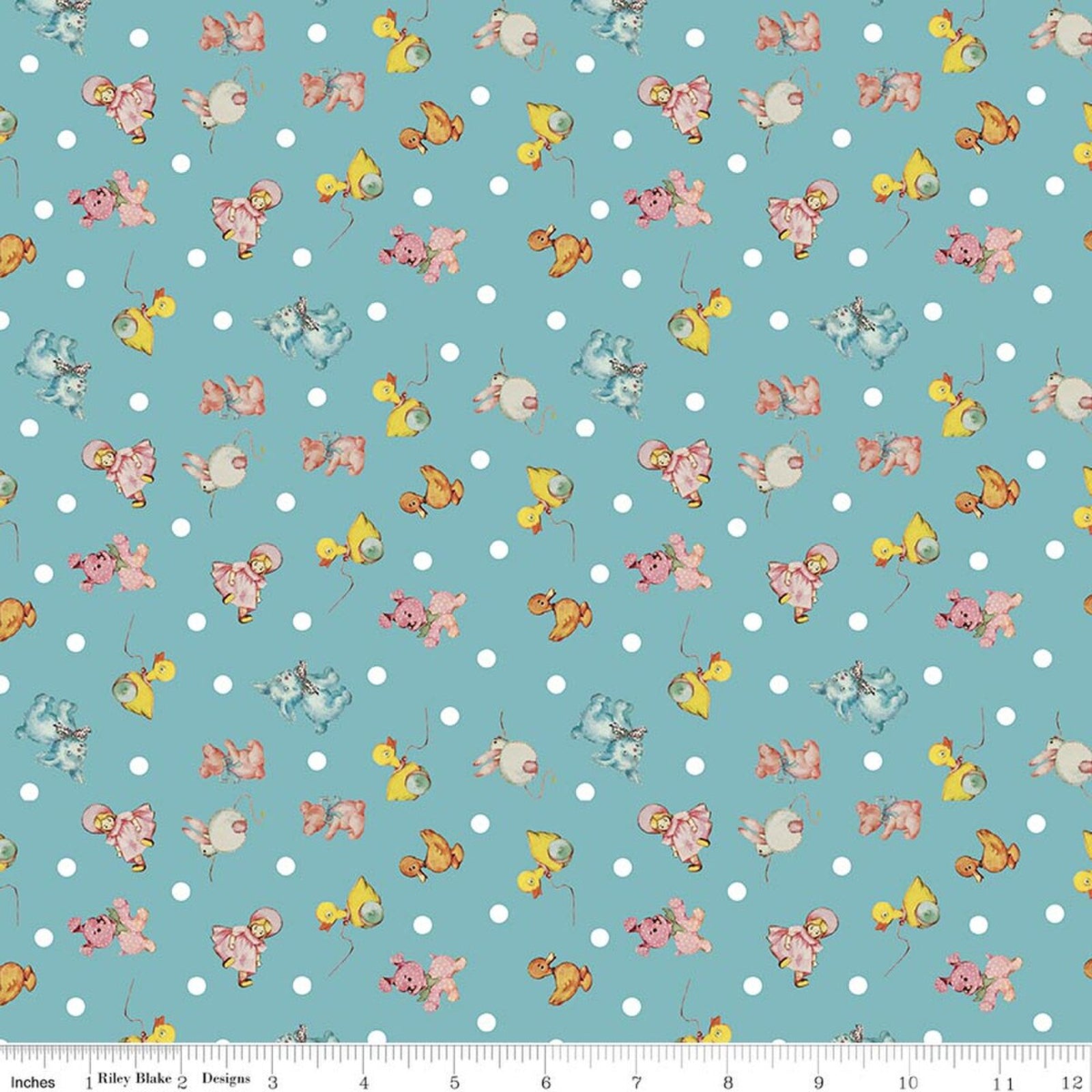 A repeating fabric pattern on a light aqua background with white polka dots and small illustrated toys in pink, yellow, blue, and beige. A ruler strip appears along the bottom edge.