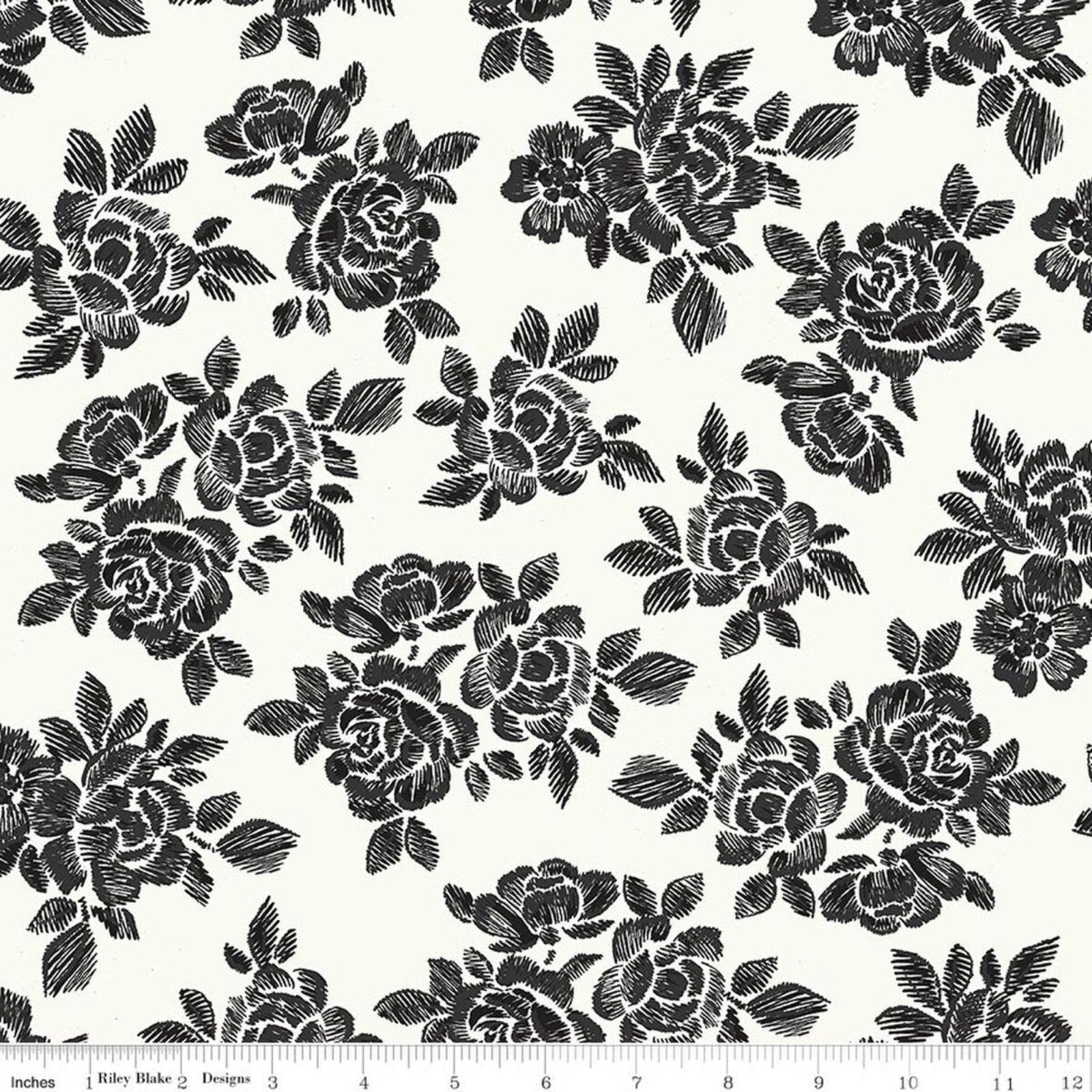 Black floral toile pattern on an off-white fabric background, shown with a ruler at the bottom indicating scale.