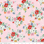 Floral pattern fabric with red, white, blue, and green flowers on a pink background.