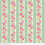 A close-up of a fabric pattern featuring vertical green stripes alternating with columns of pink roses, yellow flowers, and green leaves on a cream background. A ruler at the bottom shows the scale of the pattern.