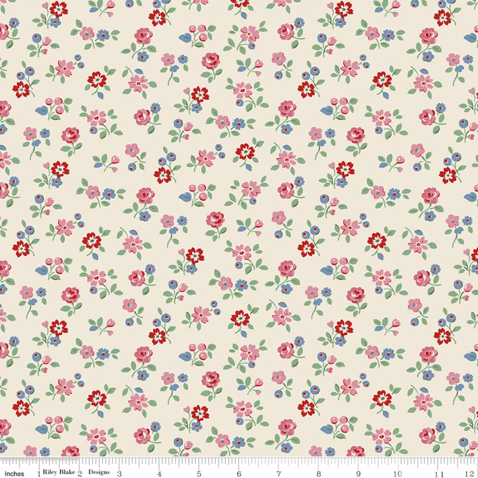 A close-up of a repeating floral fabric pattern on a warm cream background, with small pink, red, and blue flowers and green leaves. A ruler along the bottom edge shows scale in inches.