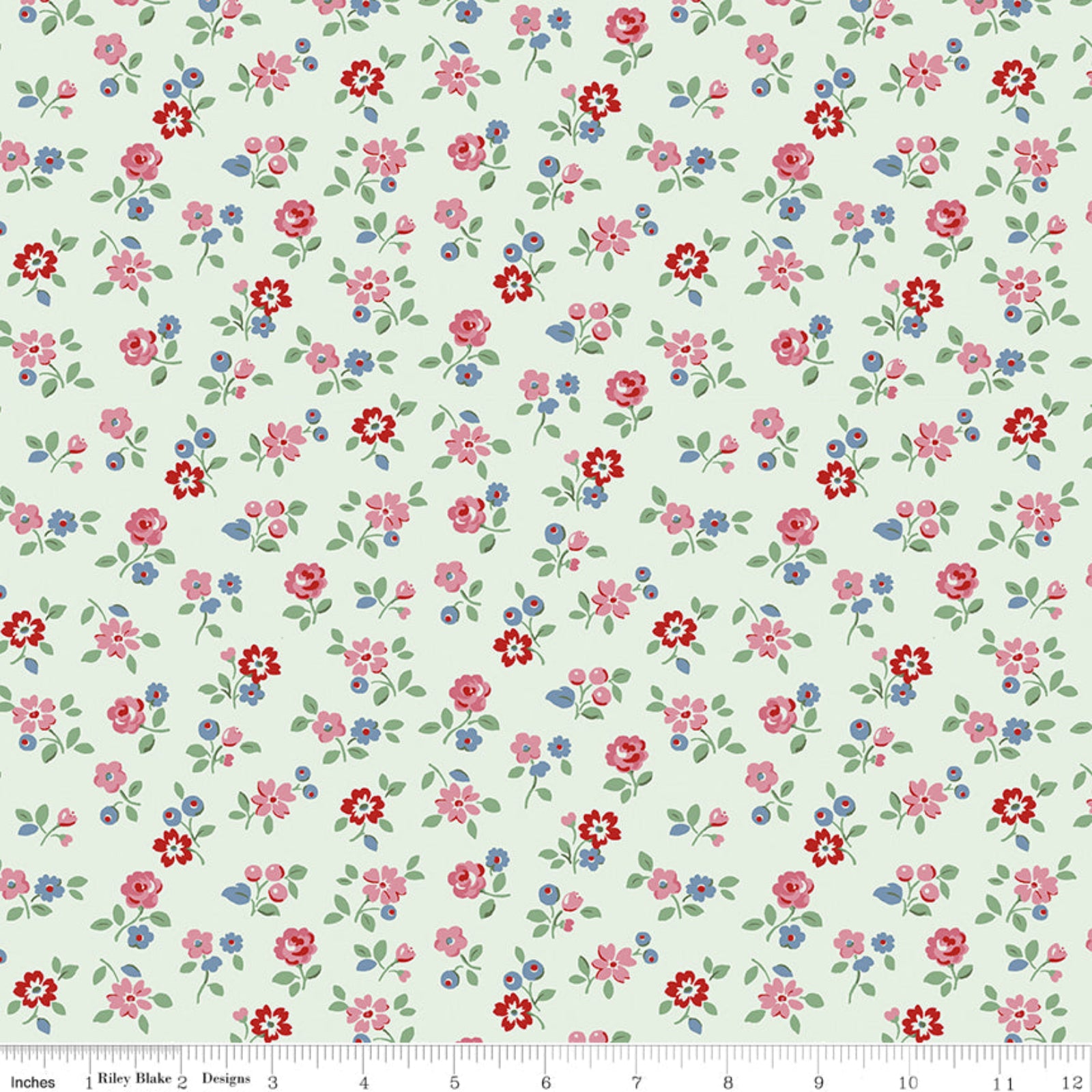 A repeating floral pattern on a pale mint green background, featuring small pink, red, and blue flowers with green leaves. A ruler along the bottom edge shows scale in inches and includes the text Riley Blake Designs.