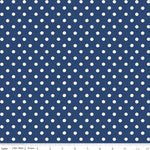A fabric pattern swatch featuring a repeating white polka dot design on a navy blue background, with a ruler scale visible along the bottom edge.