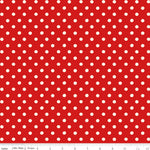 Red fabric with white polka dots and a ruler at the bottom.