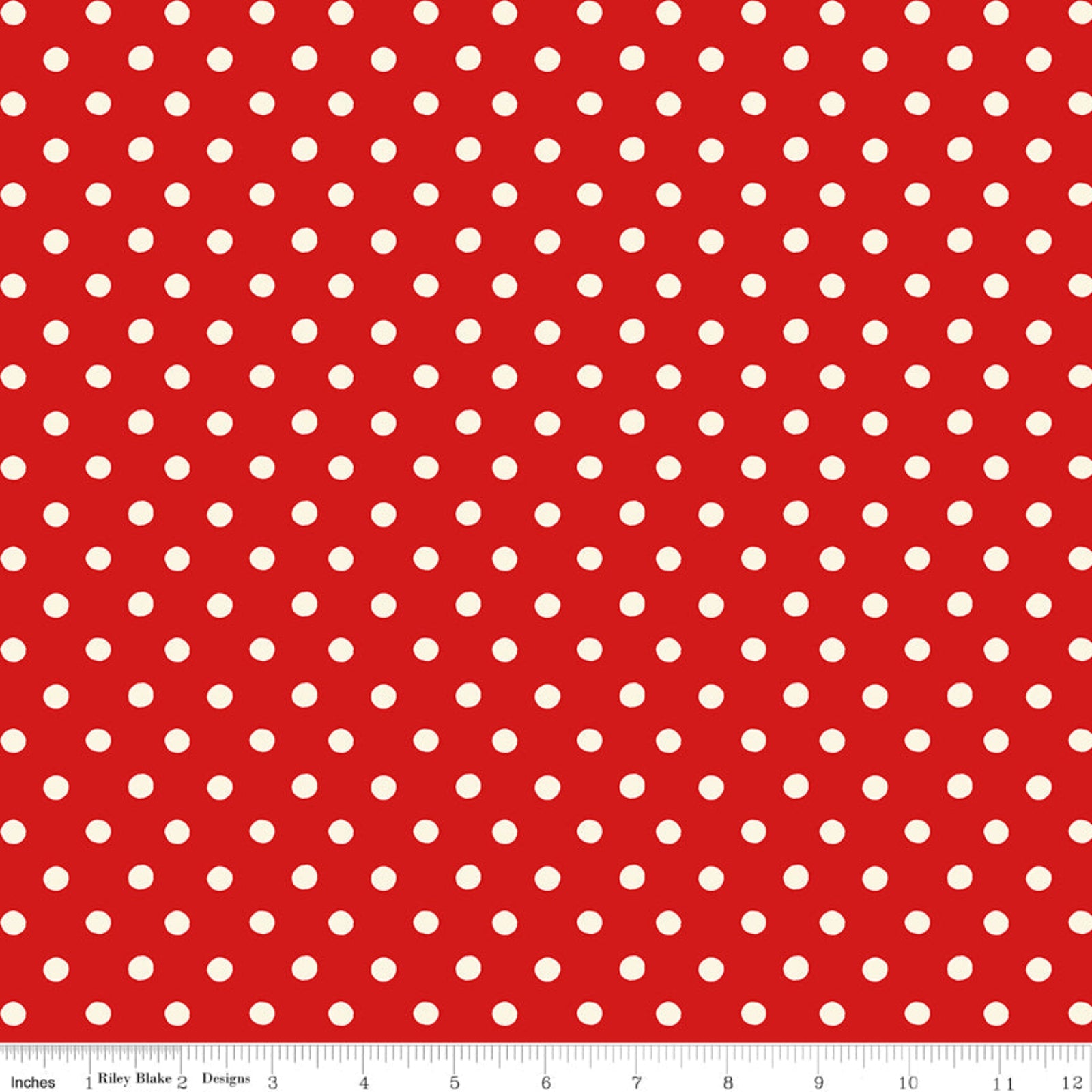 Red fabric with white polka dots and a ruler at the bottom.
