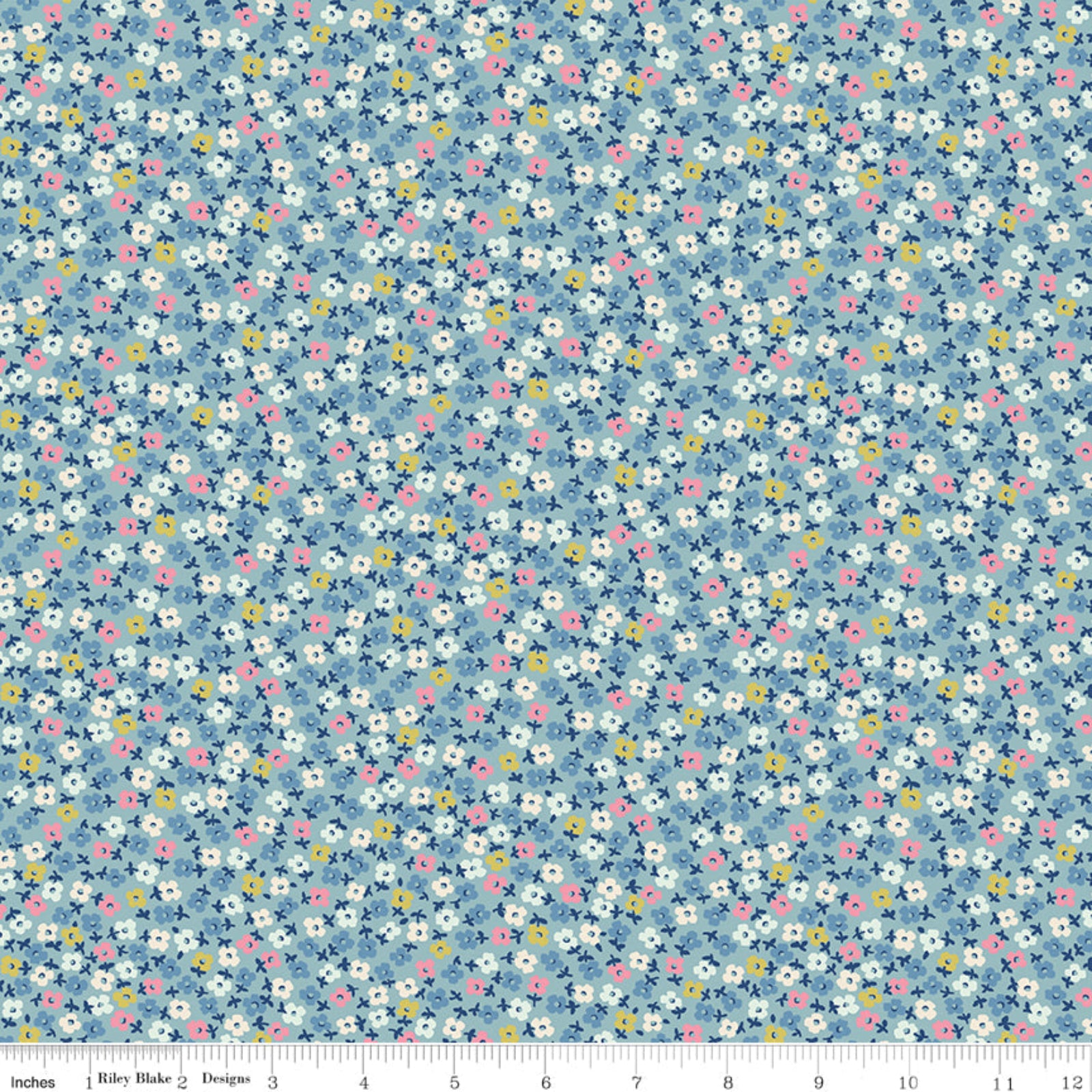 A close-up of a fabric pattern featuring a dense, small-scale floral print on a dusty blue background. The flowers are primarily white with yellow centers and pink accents, interspersed with small dark blue leaves and stems.