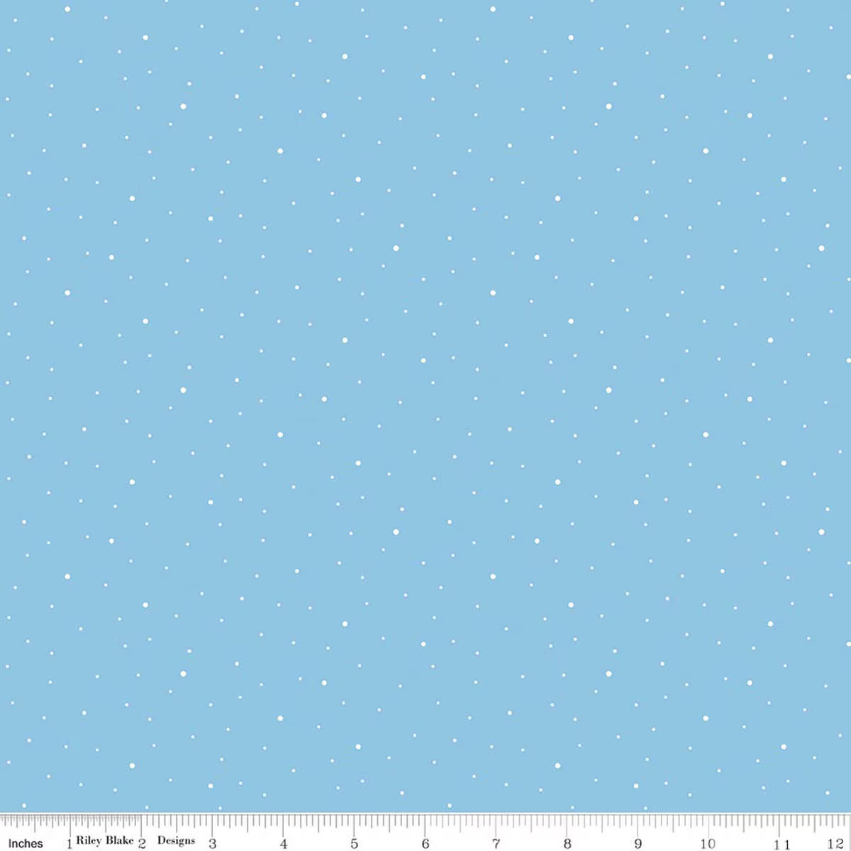 Light blue fabric with a scattered white snowflake pattern, shown with a ruler at the bottom indicating scale.