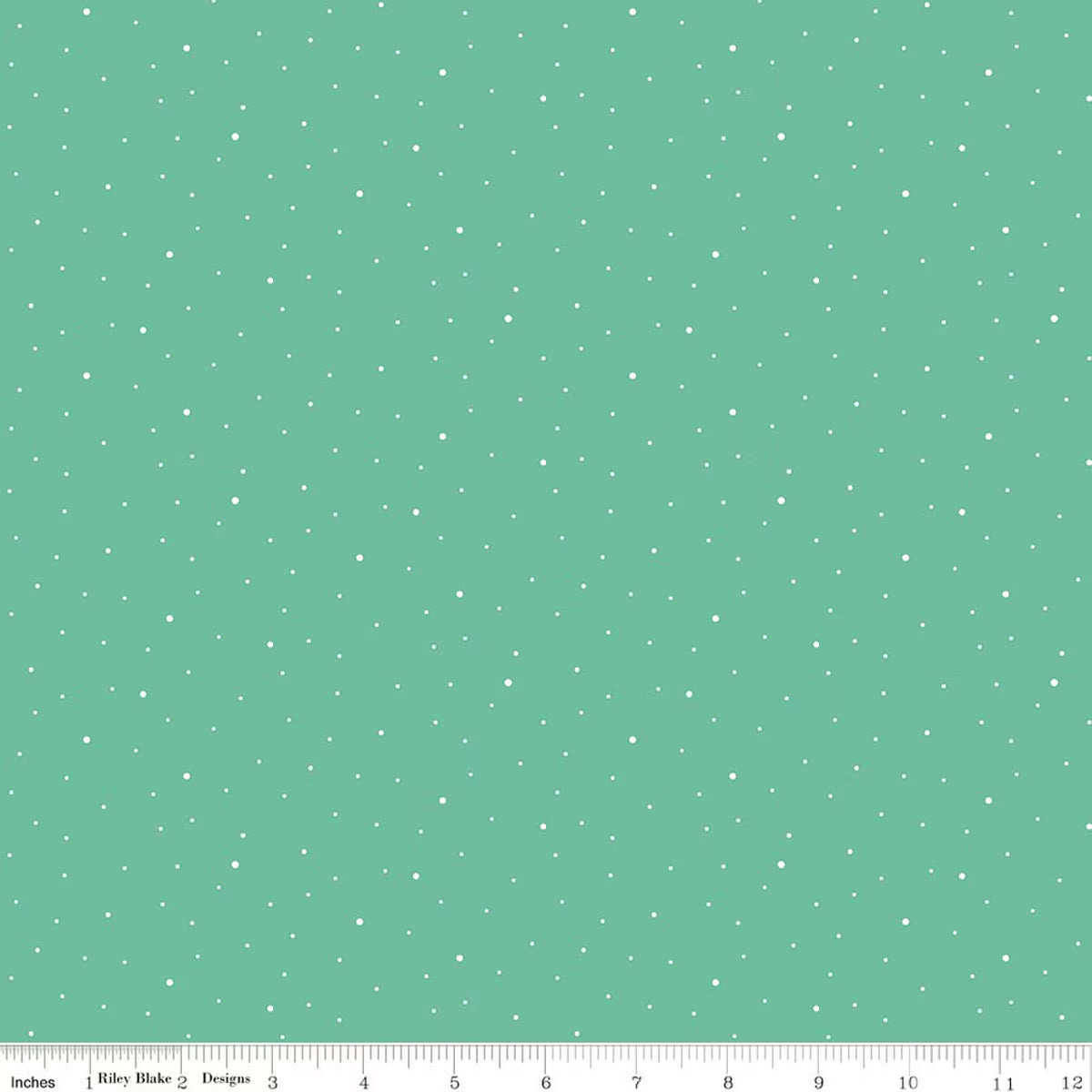 A repeating pattern of small white dots on a mint green background, shown as a fabric or paper swatch with a ruler along the bottom edge.