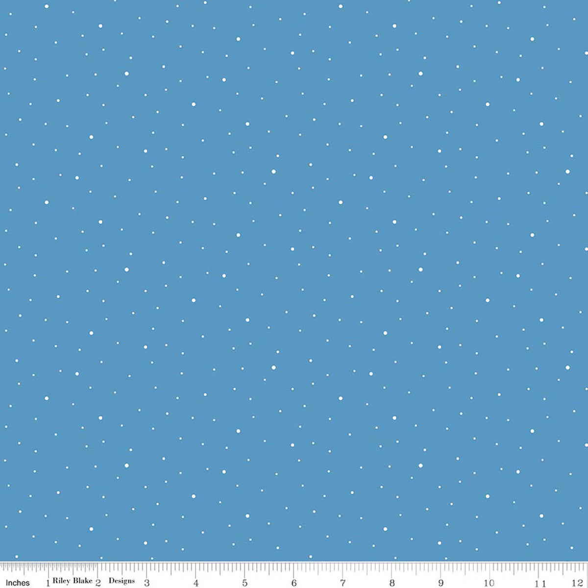 A flat blue fabric or material swatch with a scattered pattern of small white dots, shown with a ruler along the bottom edge for scale.