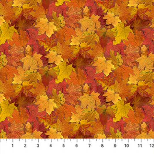 Fabric with a pattern of autumn leaves in red, orange, and yellow on a white background.