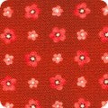 Red fabric with small floral patterns on a brown background
