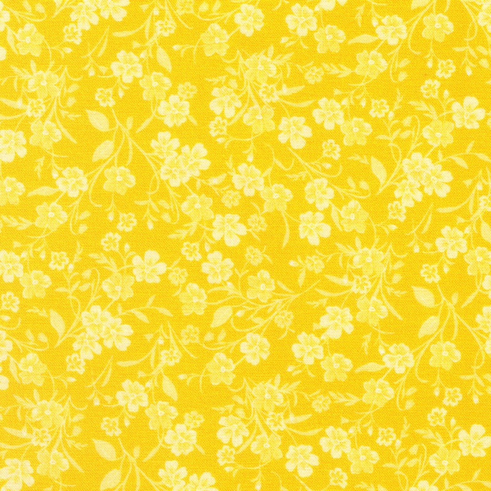 A close-up of a yellow floral pattern with small pale yellow flowers and delicate stems repeated across the surface.