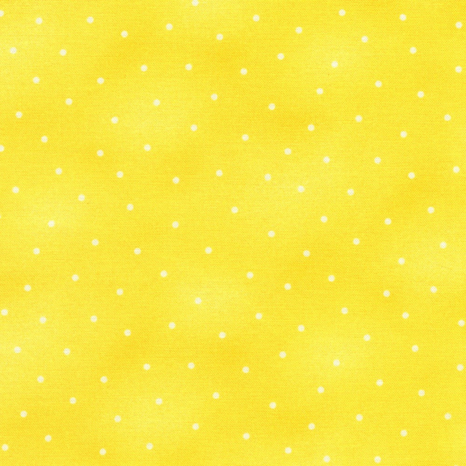 Yellow fabric with a white polka dot pattern, showing a soft watercolor texture.