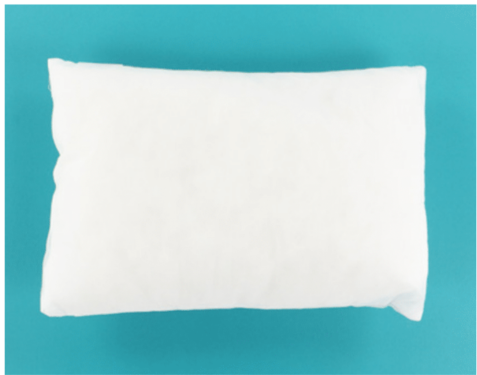 A plain white rectangular pillow or cushion shown from above on a solid turquoise background.