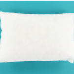 A plain white rectangular pillow or cushion shown from above on a solid turquoise background.