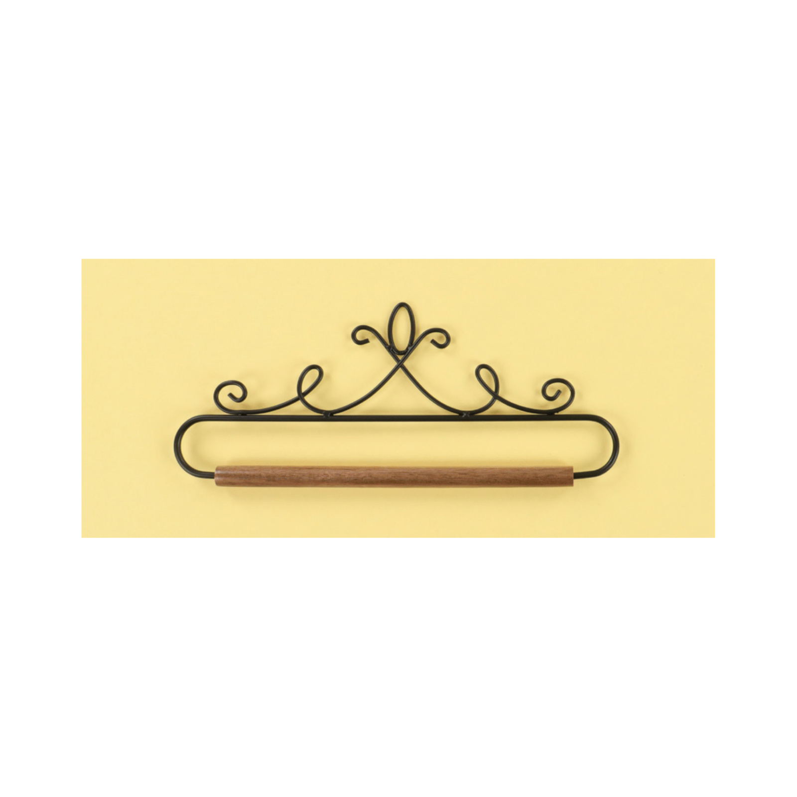 A black metal scrollwork wall hook with a horizontal bar, shown against a pale yellow rectangular background on a white field.