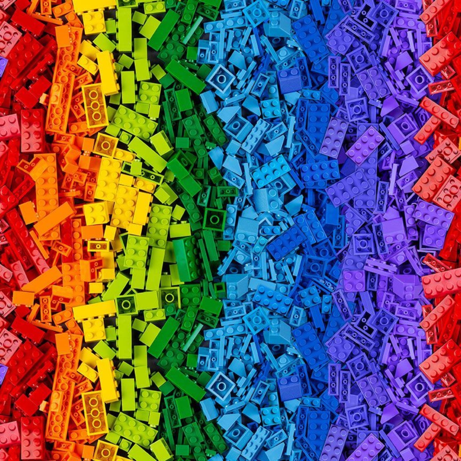 Colorful array of interlocking plastic bricks arranged in a rainbow pattern.