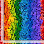 Rainbow-colored pile of toy building blocks arranged in vertical rainbow bands, with a clear ruler showing the scale on the left and bottom edges.