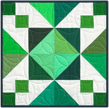 Quilt block with green and white geometric pattern
