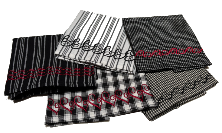 Group of black‑and‑white patterned napkins featuring decorative embroidered borders in red and black thread.
