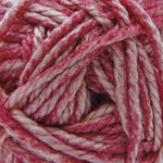 A close-up of variegated yarn with alternating strands of dusty rose pink and off-white.