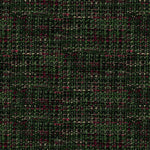 A close-up of a woven fabric texture with a dark green and black plaid pattern, accented by small pink and beige flecks.