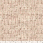 A close-up of a woven fabric texture in a warm beige and light brown herringbone pattern, with a white ruler along the bottom edge showing measurement markings.