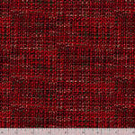 A close-up of a woven fabric texture in a red and black plaid pattern, with a white ruler at the bottom edge showing scale.
