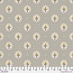 A repeating fabric pattern featuring stylized white flowers with yellow centers and gray stems, set on a warm taupe-gray background with a subtle geometric pattern. A ruler scale is visible along the bottom edge.