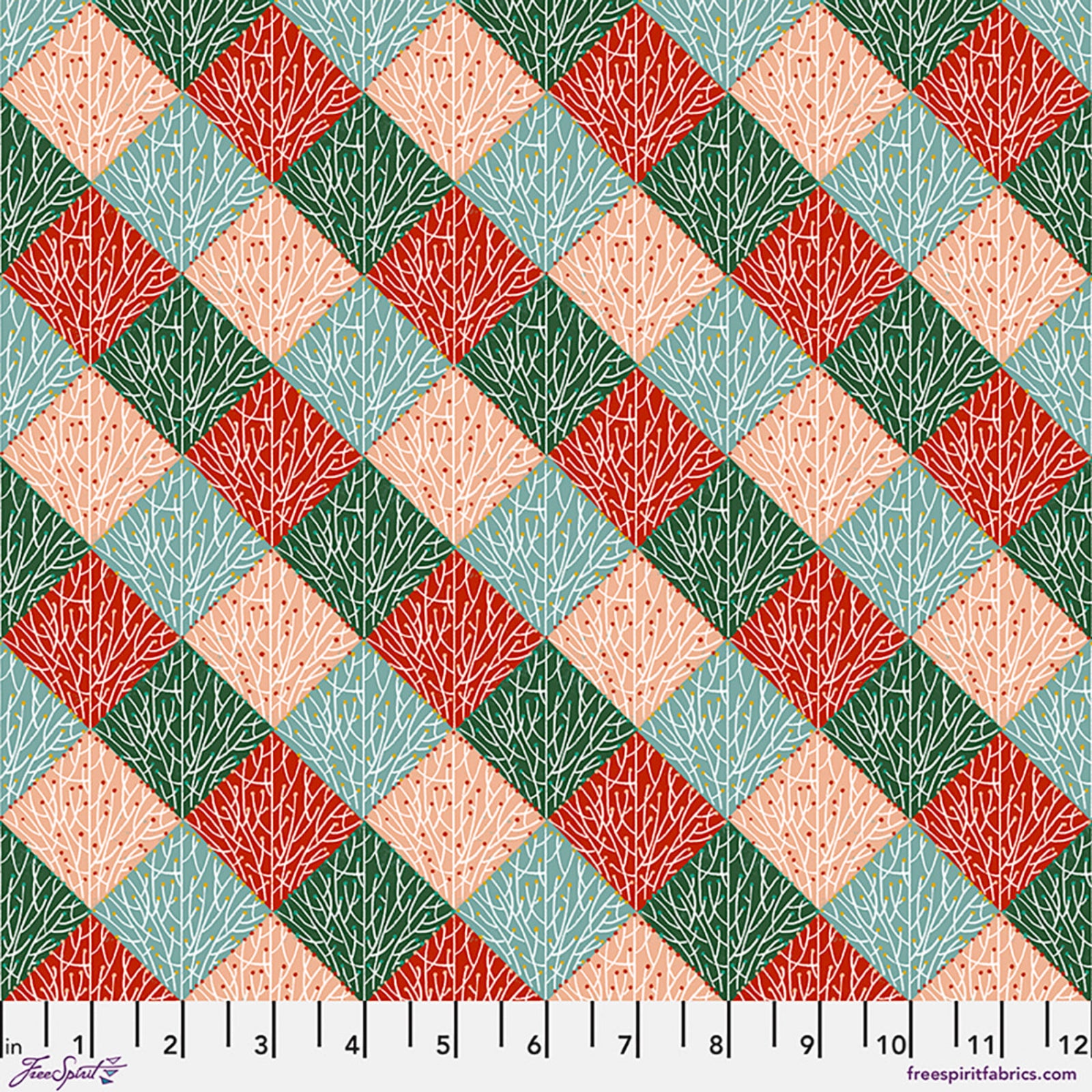 A repeating diamond patterned fabric design with coral pink, red, sage green, and light blue sections, each filled with a white branch or leaf motif. A white ruler along the bottom edge shows measurements in inches.