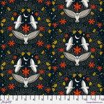 A repeating fabric pattern featuring white owls, red starburst motifs, yellow crescent moons, and small white stars on a dark navy background, with a white measurement ruler along the bottom edge.