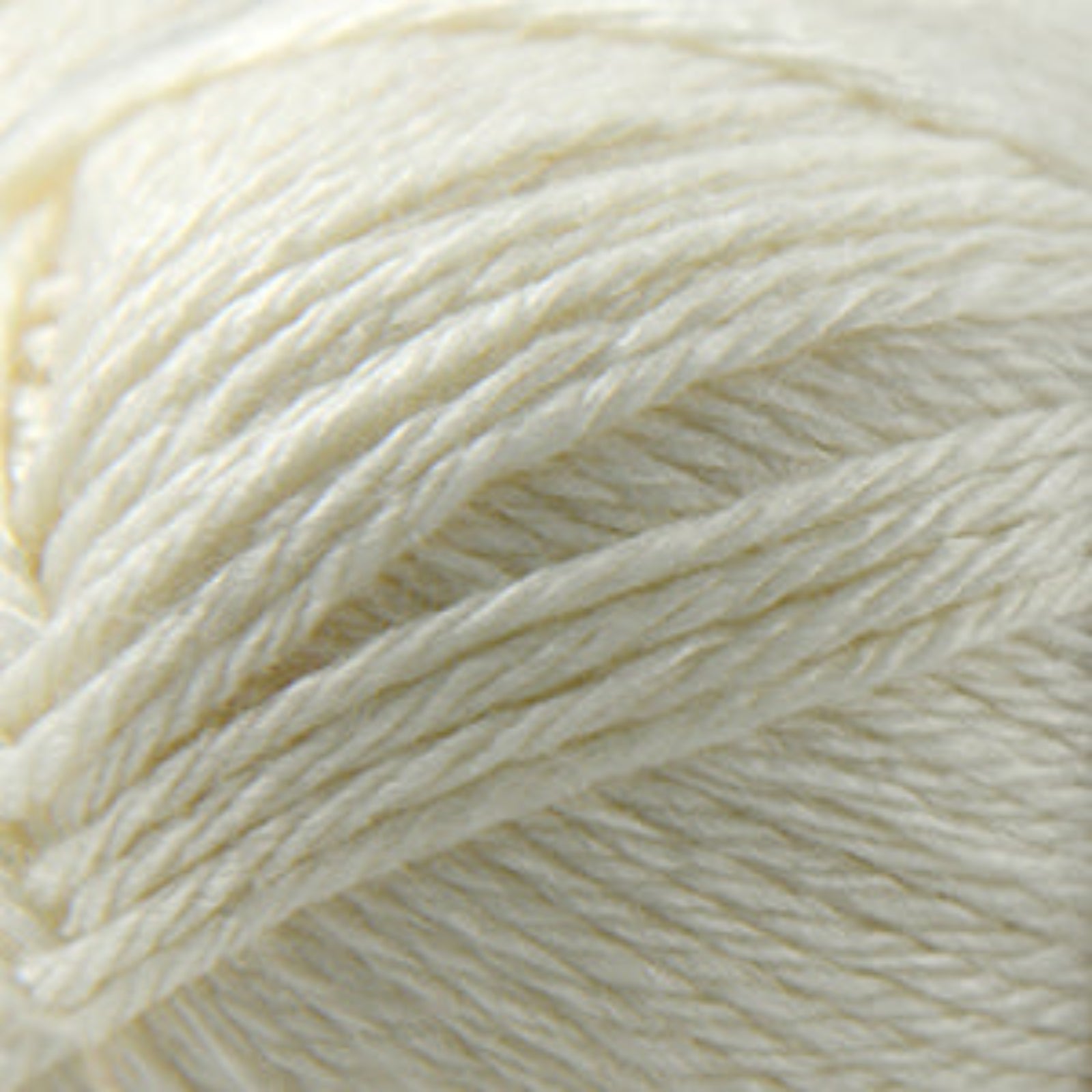 Close-up of a ball of cream-colored yarn