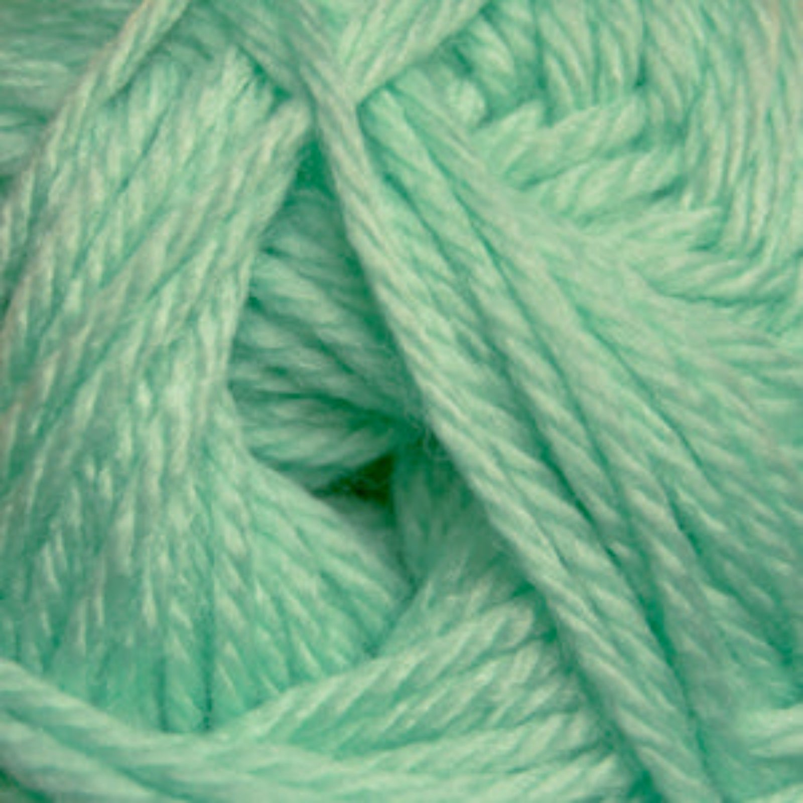 Close-up of a ball of light green yarn