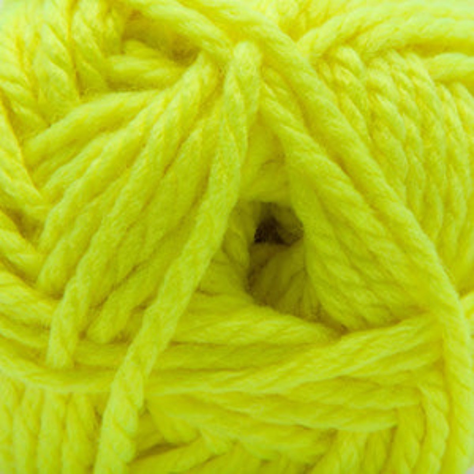 A close-up of bright neon yellow yarn wound into a skein, filling the entire frame.