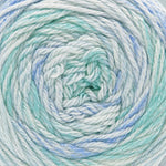 Close-up of a ball of yarn with a gradient of blue and green colors.