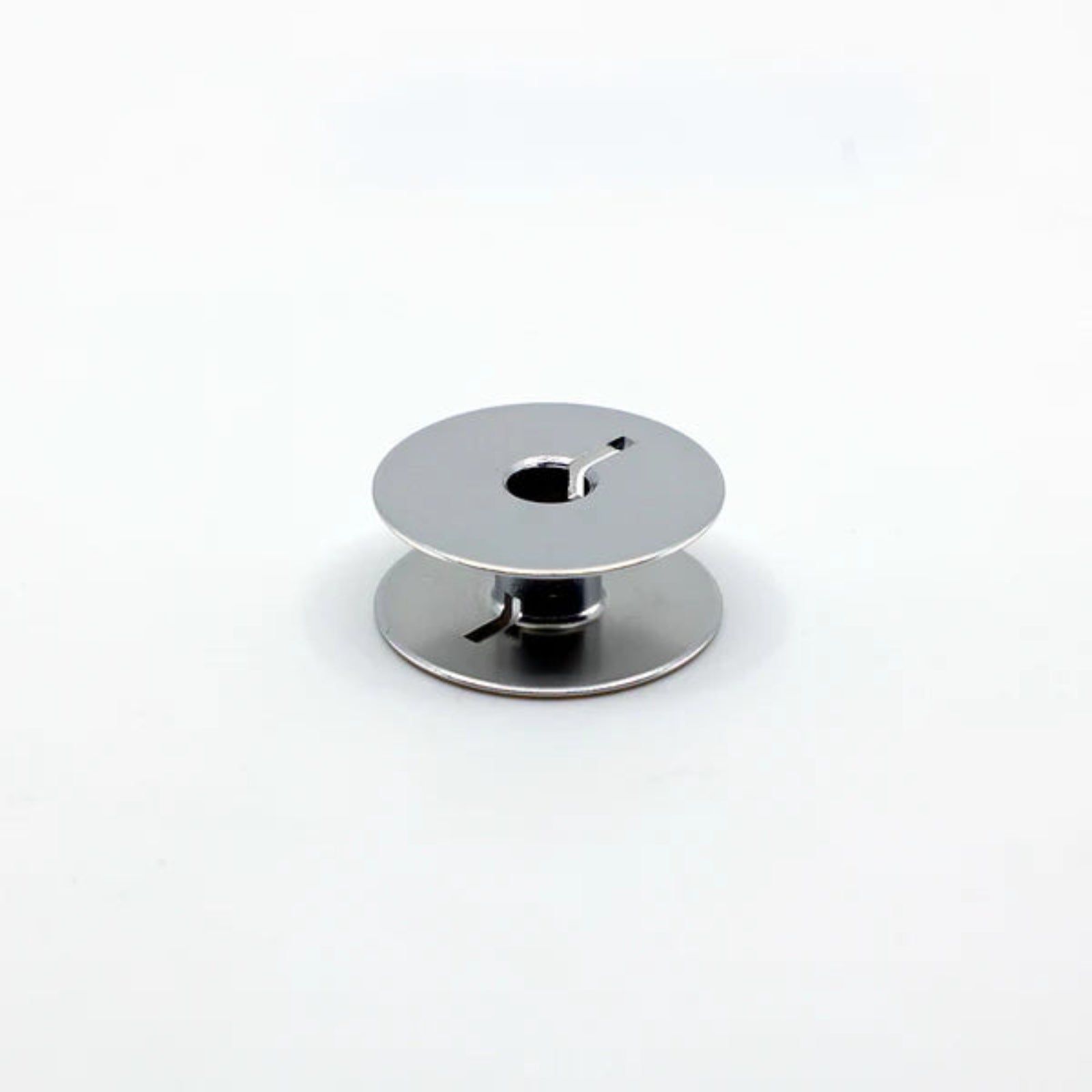 Metallic bobbin on a white background