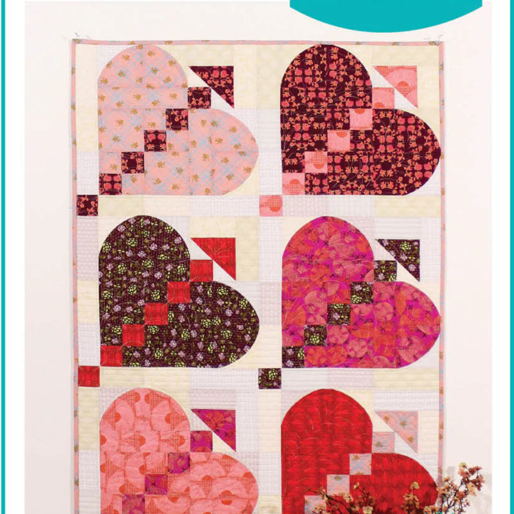 Quilt pattern with heart shapes featuring 'POSH Love' and 'Sew Kind of Wonderful' branding.